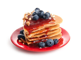 Plate with tasty pancakes in shape of heart, blueberry and jam on white background. Valentine's Day celebration