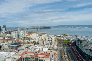 aerial shot of the San Francisco Oakland Bay Bridge, Oracle Park and office buildings and...