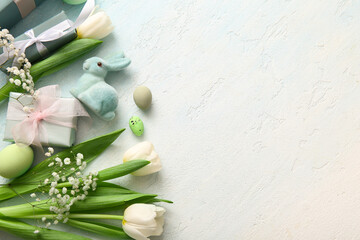Easter eggs with flowers, gift boxes and bunny on grunge blue background