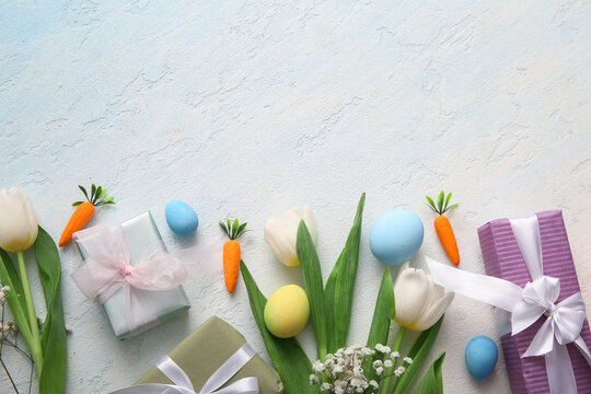 Easter eggs with gift boxes and flowers on blue grunge background