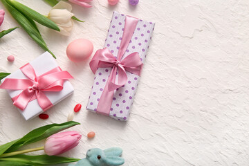Easter egg with gift boxes and tulip flowers on white background