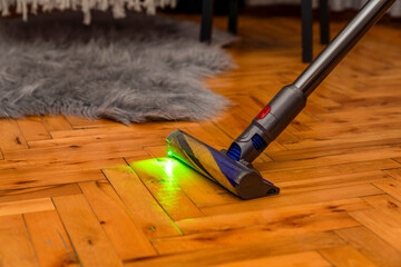 modern cordless vacuum cleaner. The motorised fluffy head reveals all the dust on the laminate...