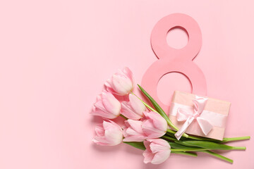 Figure 8 made of paper with beautiful tulips and gift box on pink background. International Women's Day