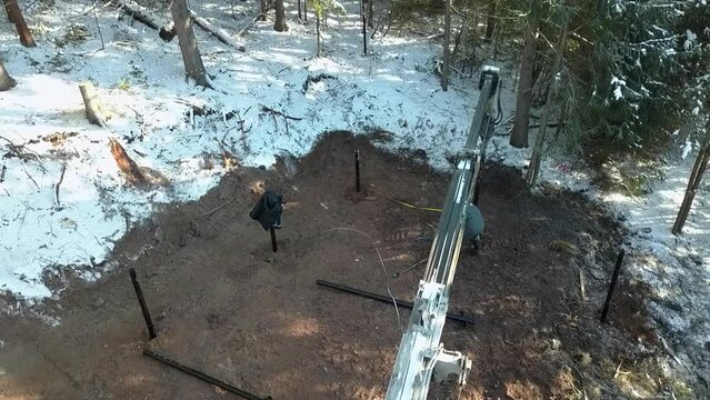 Work on a construction site during winter. Clip. Industrial background outdoors in winter forest.