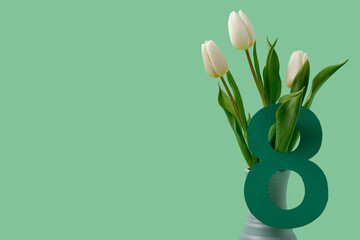 Vase with beautiful white tulips and figure 8 made of paper on green background. International Women's Day