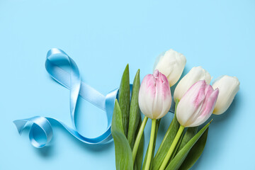 Composition with figure 8 made of ribbon and flowers on blue background. International Women's Day celebration