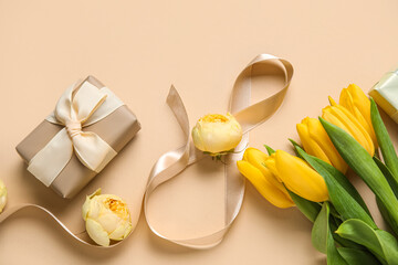 Composition with figure 8 made of ribbon, flowers and gift box on beige background. International Women's Day celebration