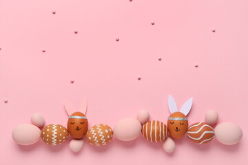 Composition with different painted Easter eggs on pink background