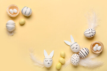 Composition with different creative Easter eggs and feathers on beige background