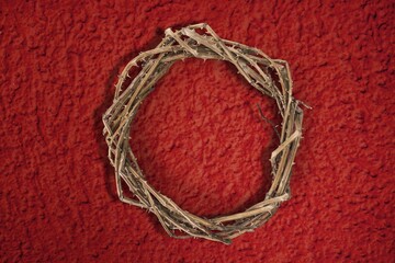 Crown of thorns of Jesus Christ on the red cloth