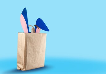 Gift bag with bunny ears. The concept of online shopping for Easter.