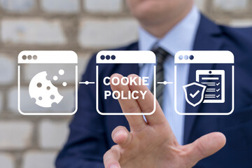 Businessman using virtual touchscreen presses inscription: COOKIE POLICY. Cookies Policy Web...