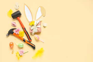 Composition with constructor's tools, gift box and Easter decor on color background