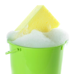 Plastic bucket with foam and sponge isolated on white. Cleaning supplies