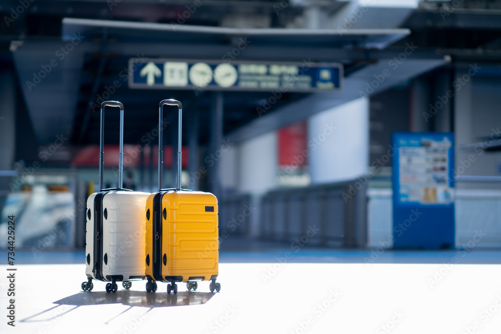 Wall mural travel, two suitcases in an empty airport hall, traveler cases in the departure airport terminal wai