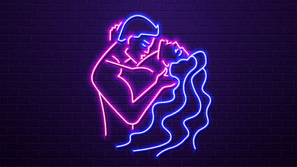 Neon silhouettes of a man and a woman kissing against a brick wall. A concept for a sex shop and erotica.