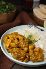 Delicious chicken curry with rice on table, closeup