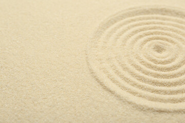 Fototapeta na wymiar Zen rock garden. Circle pattern on beige sand