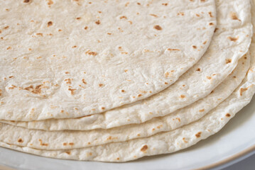 Stacked Flour Tortillas on a Plate - 734433653