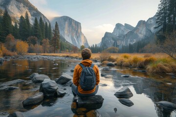 A lone hiker contemplates the vastness of the wilderness, perched upon a rocky throne in the midst of a serene river, surrounded by towering mountains and a sprawling sky