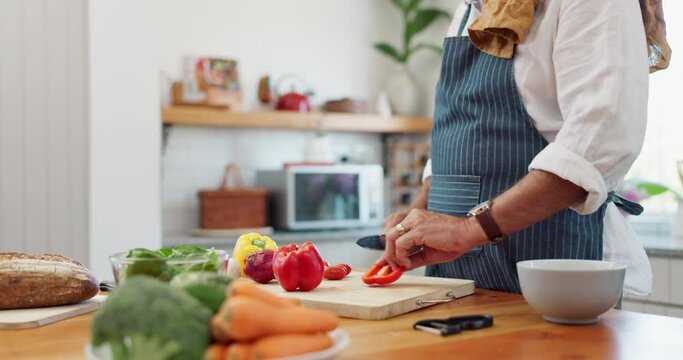 Cooking, hands and man with healthy food for meal prep, nutrition and cutting fresh ingredients for lunch. Diet, vegetables and home chef at kitchen counter with knife, recipe and salad for dinner.