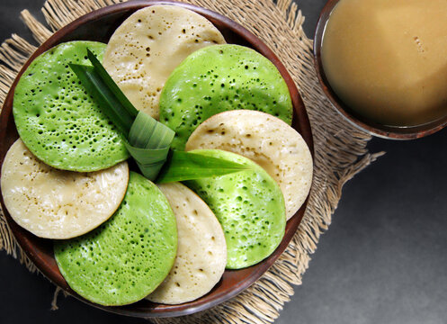 Serabi Pandan, Javanese Asian coconut-milk and pandanus pancakes with syrup of coconut milk and palm sugar. Served in traditional Java Indonesia Asia culture style