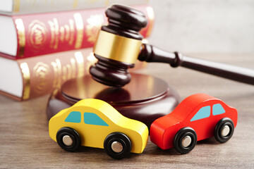 Car accident lawsuit and insurance, Judge hammer with car model.