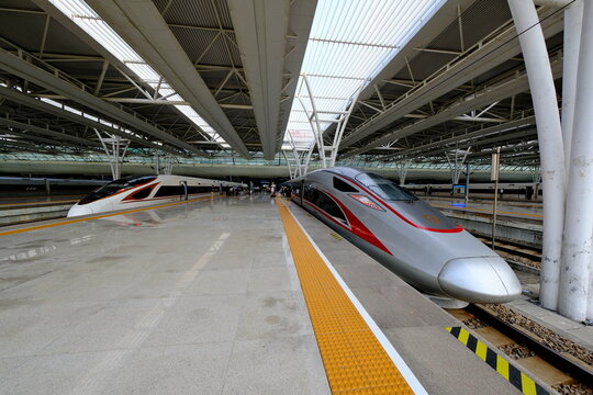 Shanghai,China-July 14th 2023: Chinese High-speed rail (HSR) train locomotive at railway station platform. wide angle