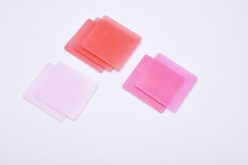pink color chips isolated on a white background, these chips are examples of product colors...