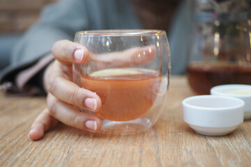 women holding cup of f lemon tea 