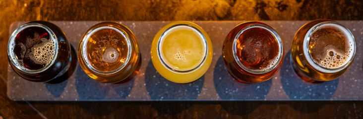 Craft beers served together in a sampler tray for the beer enthusiast in a brewery in Colorado. Selective focus.