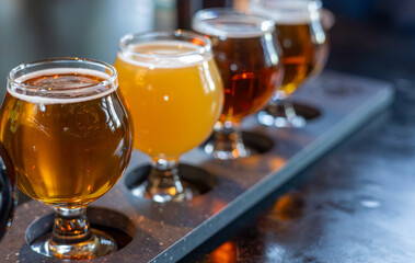 Craft beers served together in a sampler tray for the beer enthusiast in a brewery in Colorado. Selective focus.