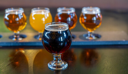 Craft beers served together in a sampler tray for the beer enthusiast in a brewery in Colorado. Selective focus.