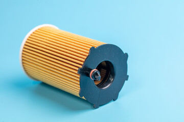 Paper oil filter on a blue background