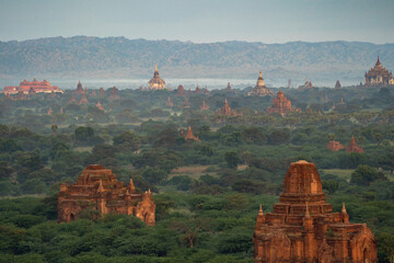 Aerial top view of burmese temples of Bagan City from a balloon, unesco world heritage with forest...