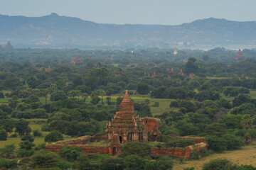 Fototapeta premium Aerial top view of burmese temples of Bagan City from a balloon, unesco world heritage with forest trees, Myanmar or Burma. Tourist destination.