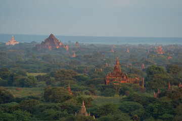 Aerial top view of burmese temples of Bagan City from a balloon, unesco world heritage with forest trees, Myanmar or Burma. Tourist destination.