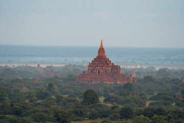 Aerial top view of burmese temples of Bagan City from a balloon, unesco world heritage with forest trees, Myanmar or Burma. Tourist destination.