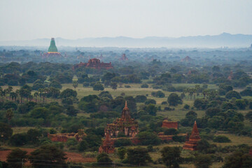 Aerial top view of burmese temples of Bagan City from a balloon, unesco world heritage with forest trees, Myanmar or Burma. Tourist destination.