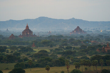 Aerial top view of burmese temples of Bagan City from a balloon, unesco world heritage with forest...