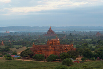 Aerial top view of burmese temples of Bagan City from a balloon, unesco world heritage with forest trees, Myanmar or Burma. Tourist destination.