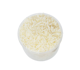 rice in the measuring cup isolated on white background.