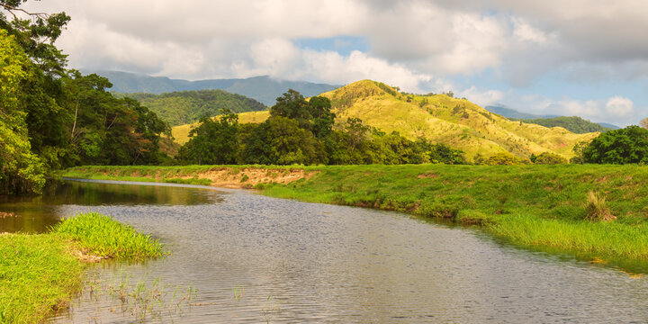 Spring landscape with a river and hills in the backdrop, Far North Queensland, Australia.