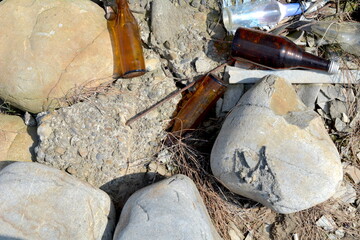 Abandoned cracked stone and glass wine bottle