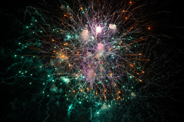 Holiday fireworks explode in the night sky. Selective focus. 