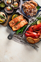 Set of Seafood dishes on light wooden background.