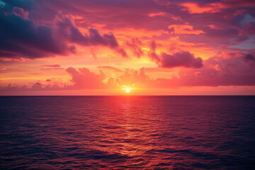 sunset over the ocean, with orange and pink clouds in the sky