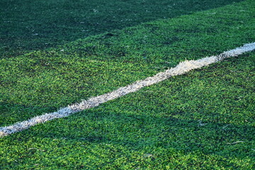 artificial green grass soccer field with white line
