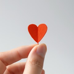 fingers hold a cute mini heart ayered paper craft