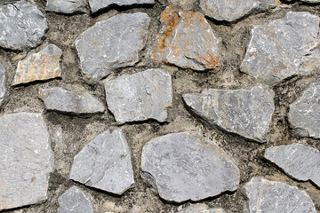 Close up textured abstract background of a stone wall